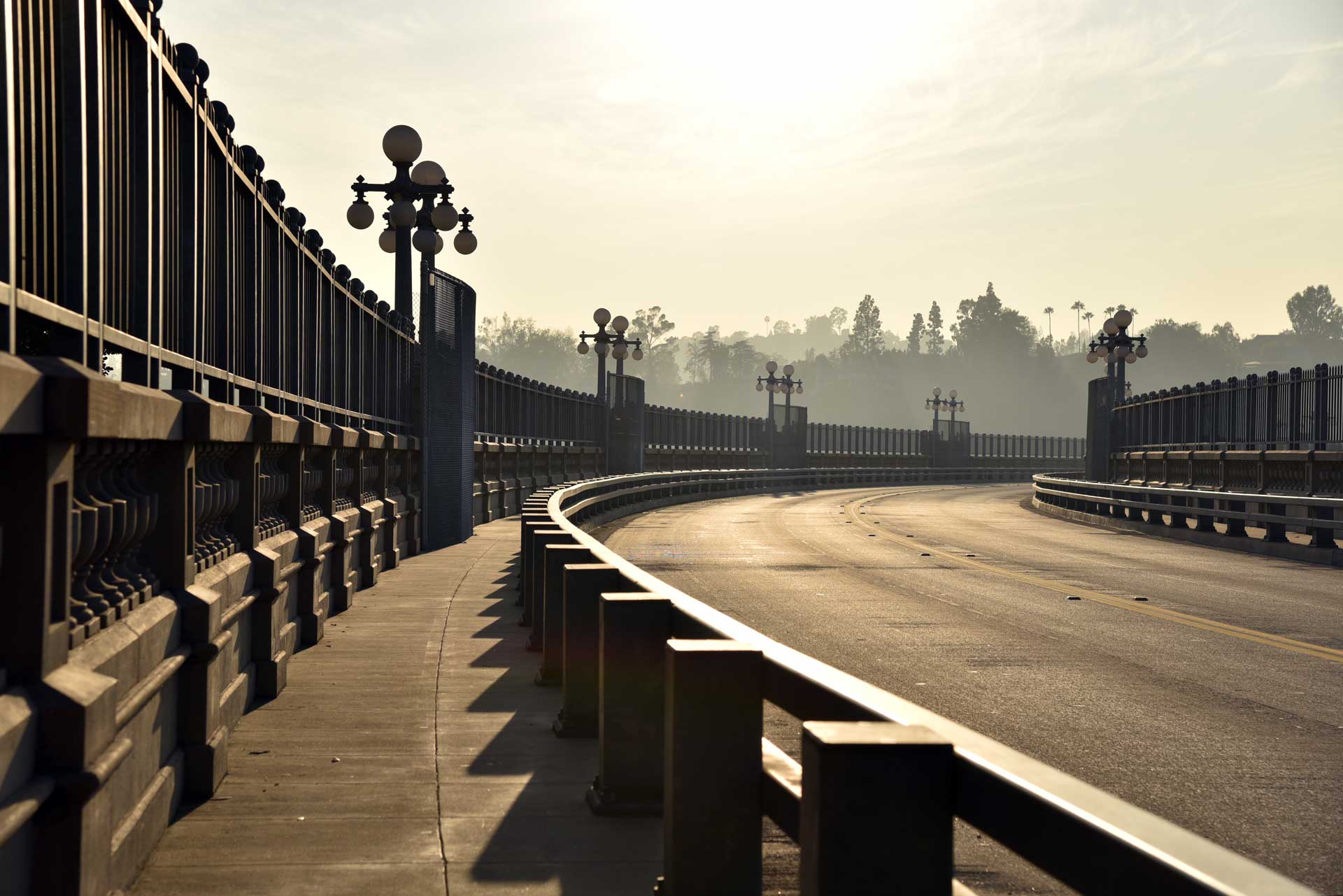 pasadena bridge in california with sun shining in the sky